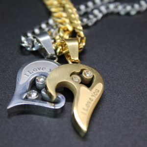 Two heart-shaped necklaces featuring a black and gold chain, elegantly displayed as the "Love You Necklace Set