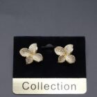A pair of elegant gold earrings adorned with sparkling crystals, showcasing a refined and luxurious design.