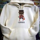 A white hoodie featuring a pixelated graphic of a basketball player in action, showcasing a modern and sporty design.